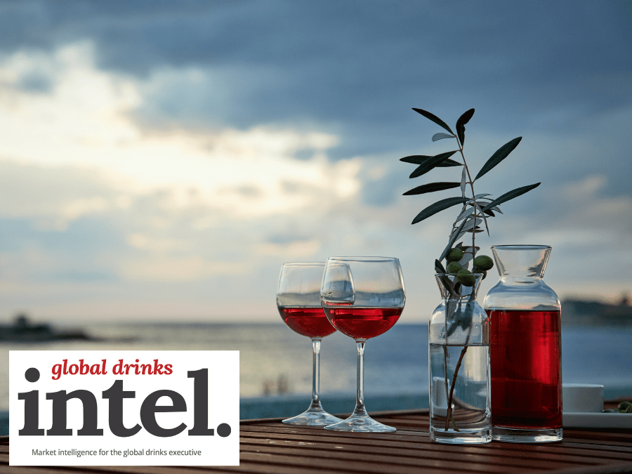 Two drinks and a bottle by the sea at sunset