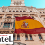 Spanish flag outside an old building with Global Drinks Intel logo