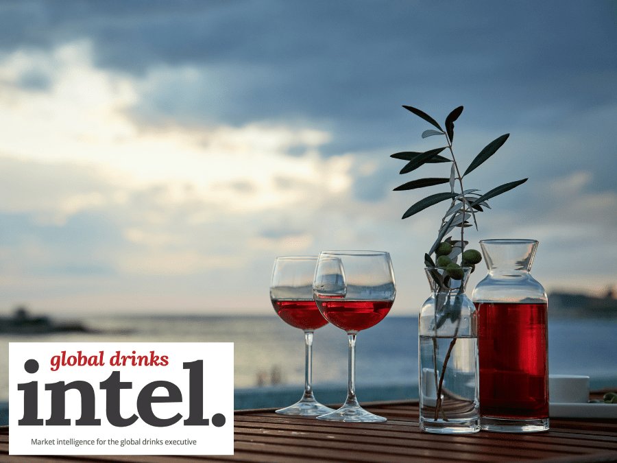 Two drinks and a bottle by the sea at sunset