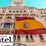 Spanish flag outside an old building with Global Drinks Intel logo