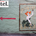 Painted sign for Absinthe La Fee Verte on wall
