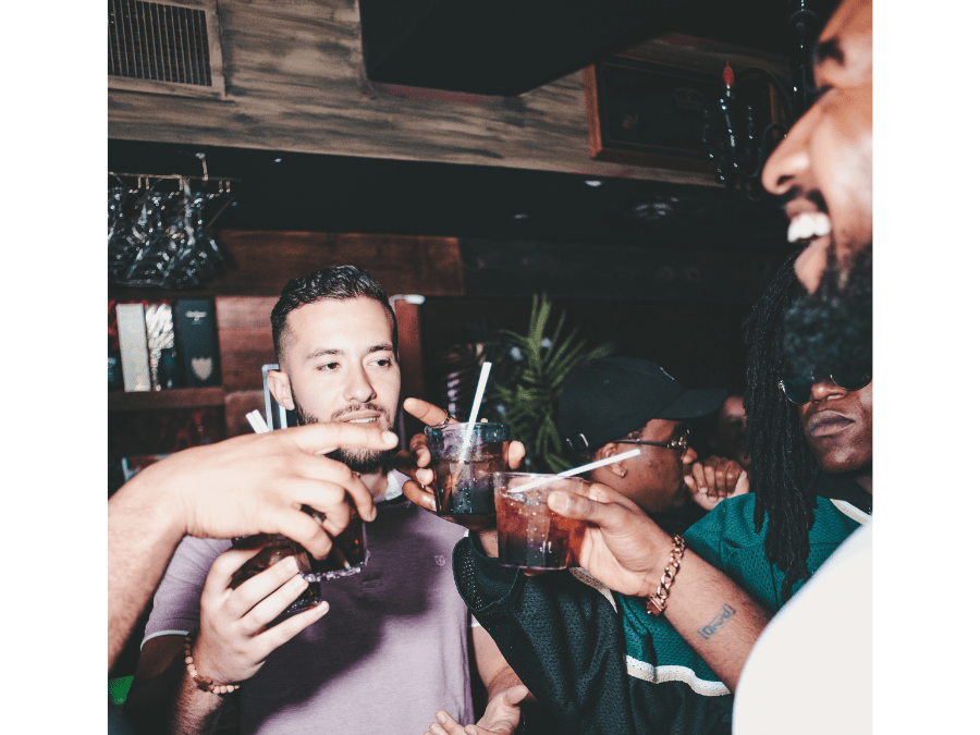 Young consumers drinking cocktails in a bar