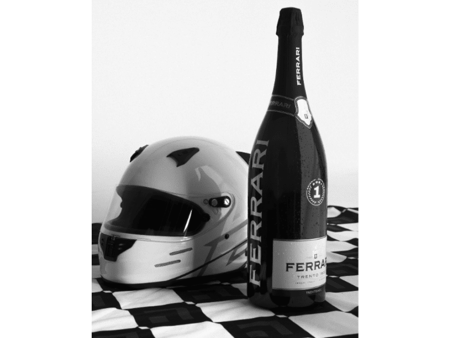 Ferrari Trento jeroboam with crash helmet on chequered flag