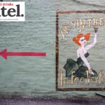 Painted sign for Absinthe La Fee Verte on wall