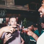 Young consumers drinking cocktails in a bar
