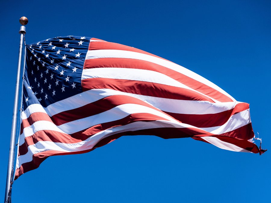 US flag on blue sky background