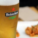 Heineken logo on side of glass of beer