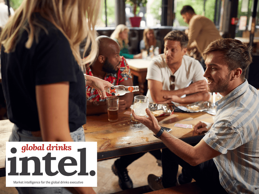 Staff pouring mixer into consumers glass in a bar