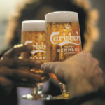 Two branded glasses of Carlsberg