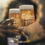 Two branded glasses of Carlsberg