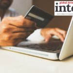 Man using credit card to pay for online purchase on a laptop