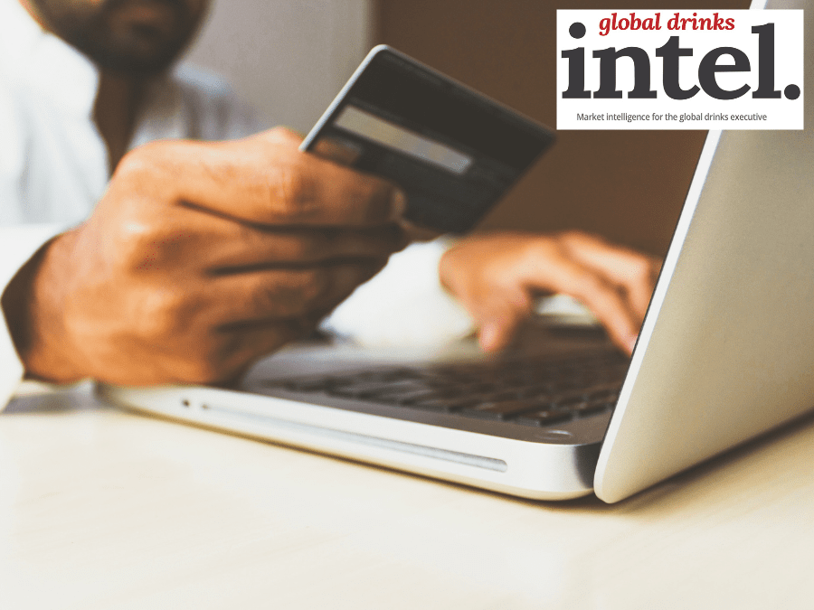 Man using credit card to pay for online purchase on a laptop
