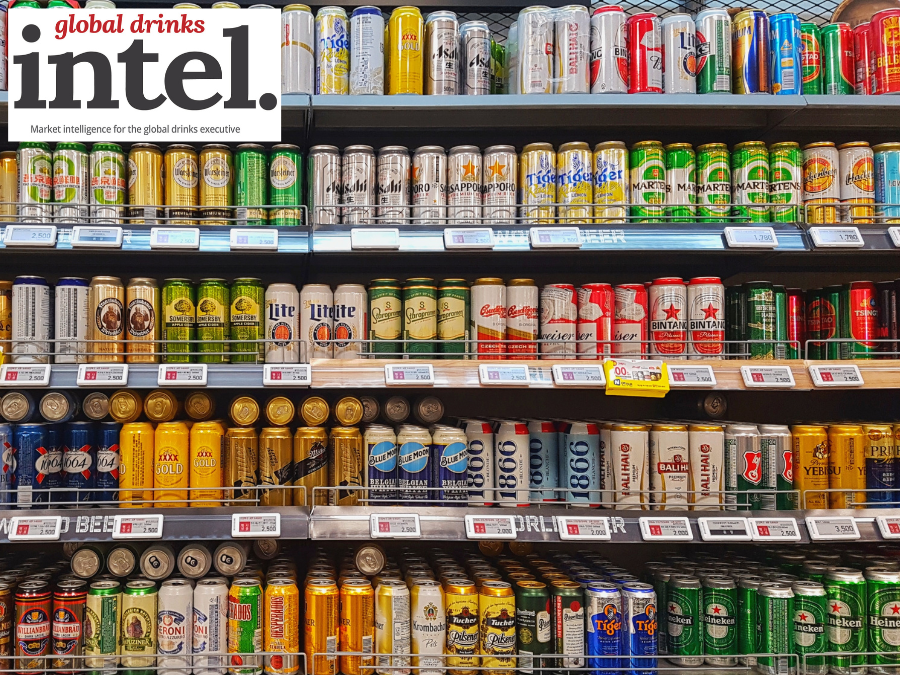 Beer cans on shelf display in supermarket