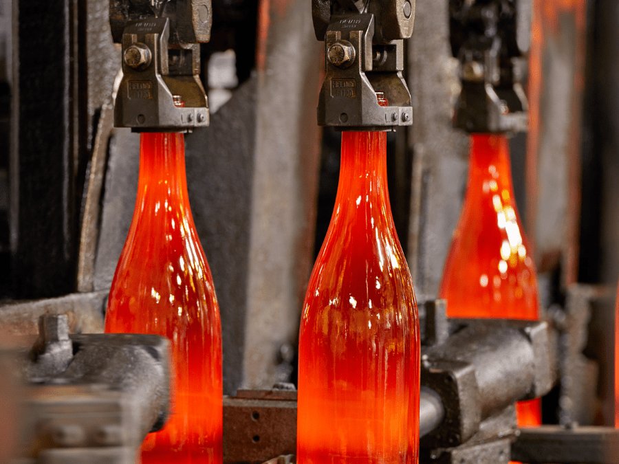 Glass bottles just out of the furnace