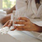 A glass of water and some headache tablets