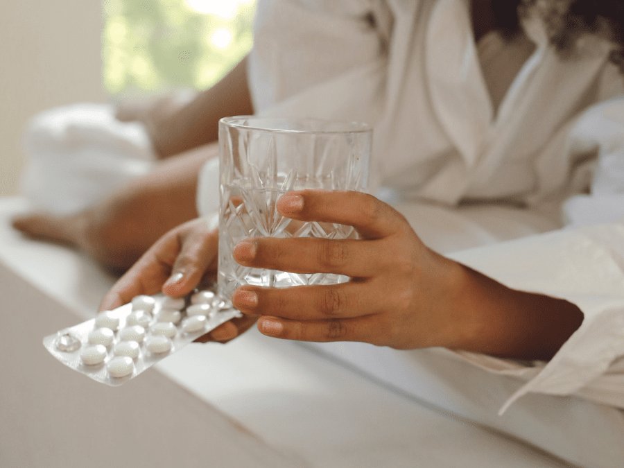 A glass of water and some headache tablets