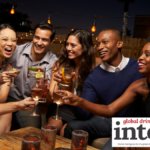 Younger LDA consumers toasting each other in a bar