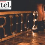 Rumble sign on floor with woman standing in front of it
