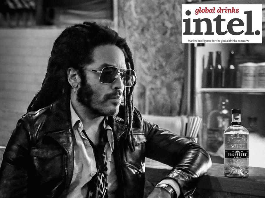 Lenny Kravitz at a bar with a bottle of new sotol brand Nocheluna