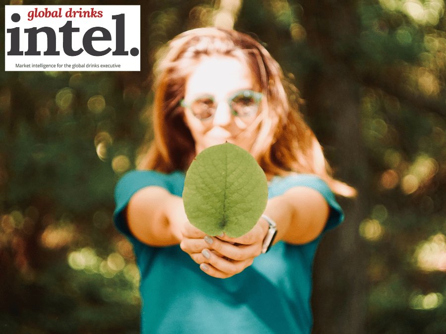 Woman holding a leaf towards the camera