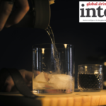 Brandy pouring into a glass with ice