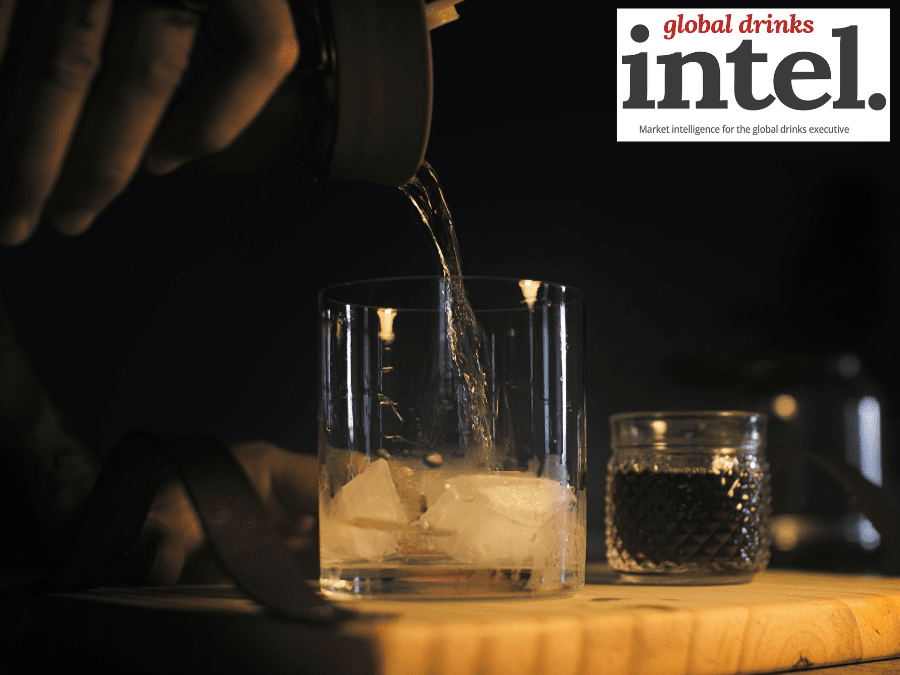 Brandy pouring into a glass with ice