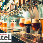 A row of beer taps in a bar with four different beers
