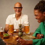 Stanley Tucci with a Birra Moretti branded glass