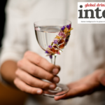 Spirit serve in glass with floral garnish