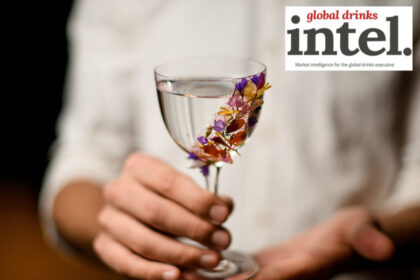 Spirit serve in glass with floral garnish