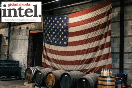 American flag above row of barrels in warehouse