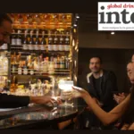 Bartender serving a cocktail to a consumer