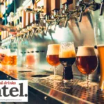 A row of beer taps in a bar with four different beers