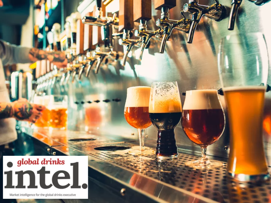 A row of beer taps in a bar with four different beers