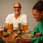 Stanley Tucci with a Birra Moretti branded glass