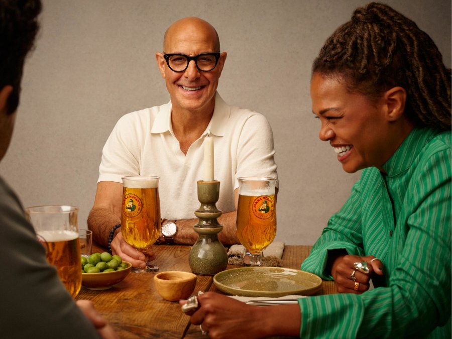Stanley Tucci with a Birra Moretti branded glass