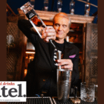 Dolph Lundgren pouring Hard Cut Vodka behind a bar