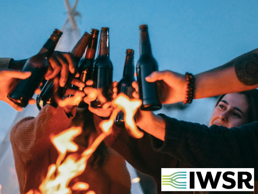Younger drinkers outdoors with bottles of beer