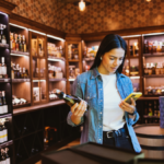 Woman looking at a phone in an alcohol off-premise outlet