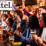 Drinkers at a bar watching sport