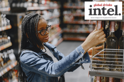 Woman in shop looking at bottles of alcohol