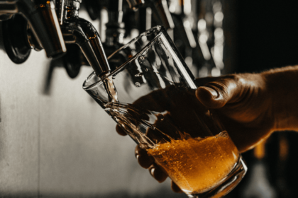A pint of beer being poured in a pub