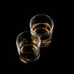 Two glasses containing aged spirit