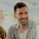 Lionel Messi standing at a bar