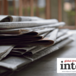 A pile of newspapers on a table