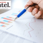 A pen pointing at a graph on a sheet of paper
