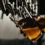 A pint of beer being poured in a pub