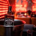 A bottle of Jack Daniel's in an ice bucket on a bar