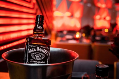 A bottle of Jack Daniel's in an ice bucket on a bar