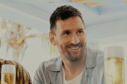 Lionel Messi standing at a bar